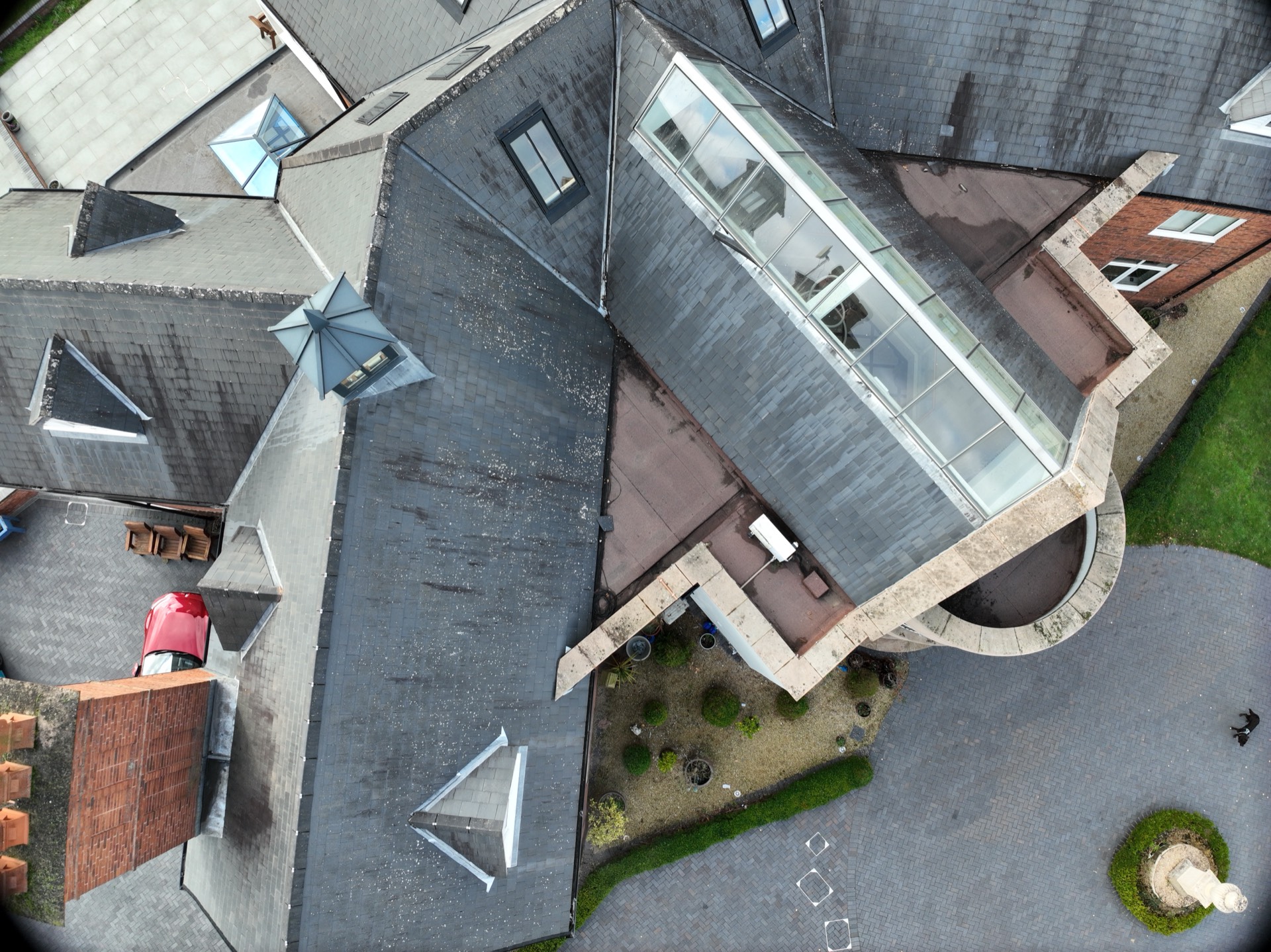 Aerial drone roof inspection showing slate tiles, skylights and chimneys